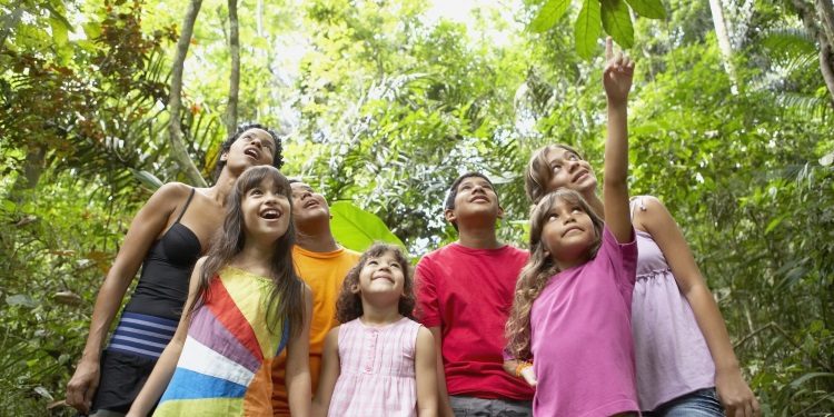 happy students on a field trip in the woods