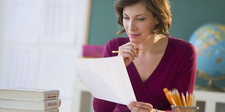 woman teacher studying something on paper